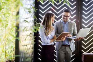 Employees enjoying the benefit of document management system in the office.