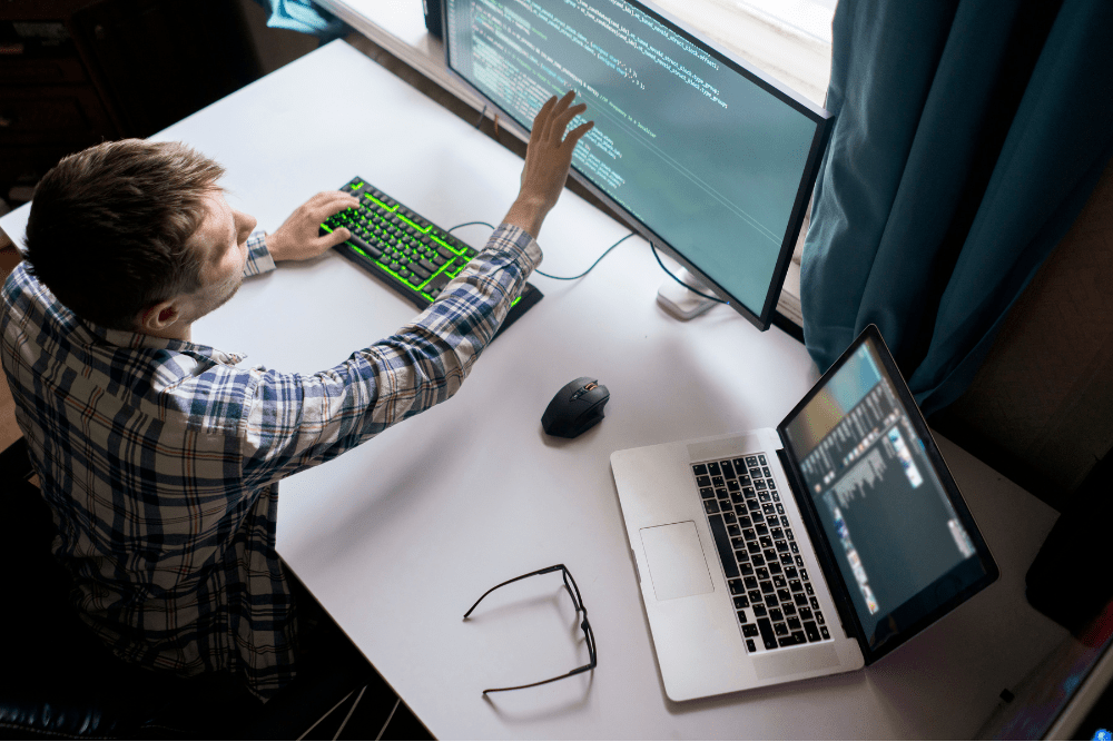 Overhead view of a cybersecurity expert assessing code